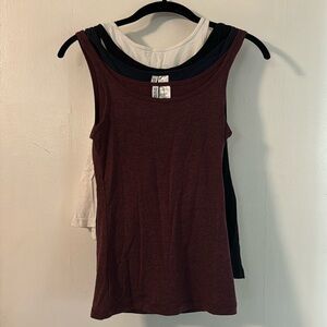 Four H&M tank tops. White, black, navy blue and maroon. Size xs.